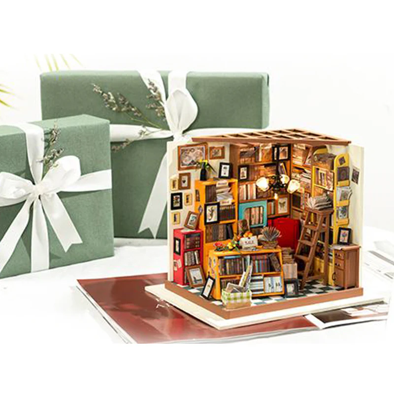 Assembled Rolife Sam's Study Library Kit displayed on a table next to green, gift-wrapped presents with white bows.