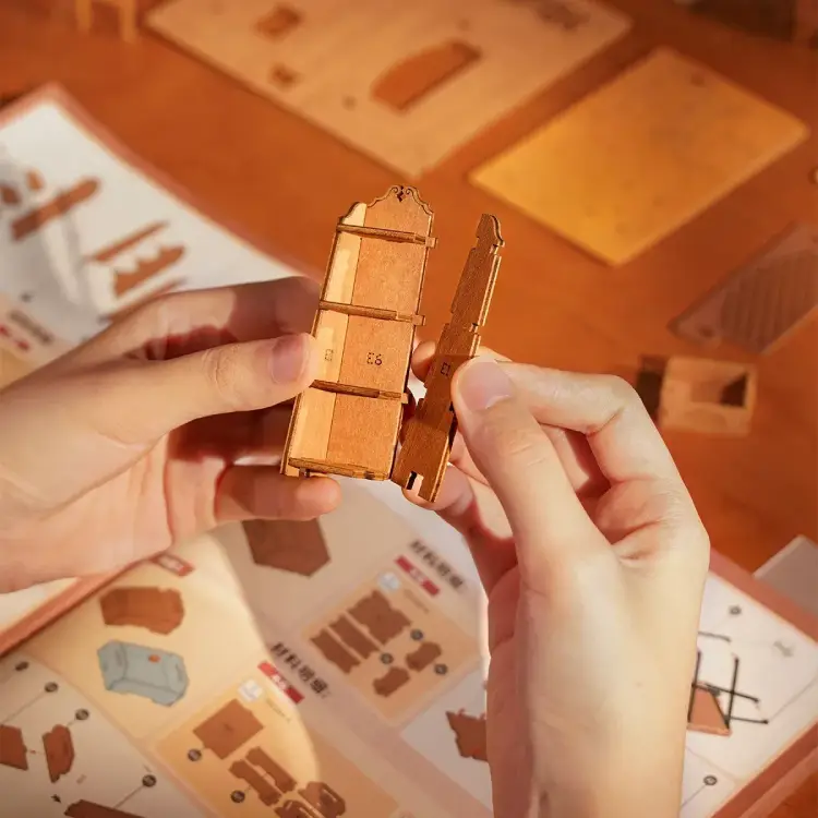 Hands assembling the Rolife Corner Bookstore with sturdy bayonet locking design.