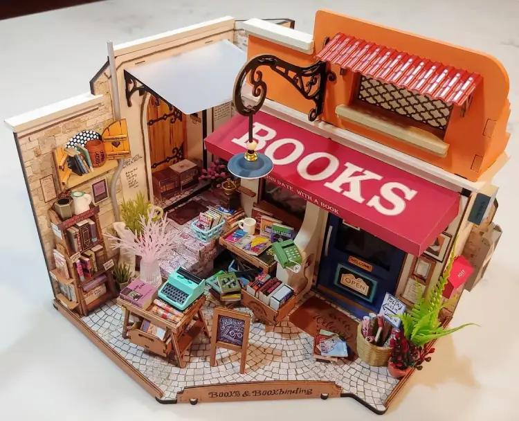 Fully assembled Rolife Corner Bookstore DIY Miniature House Kit against a white background.