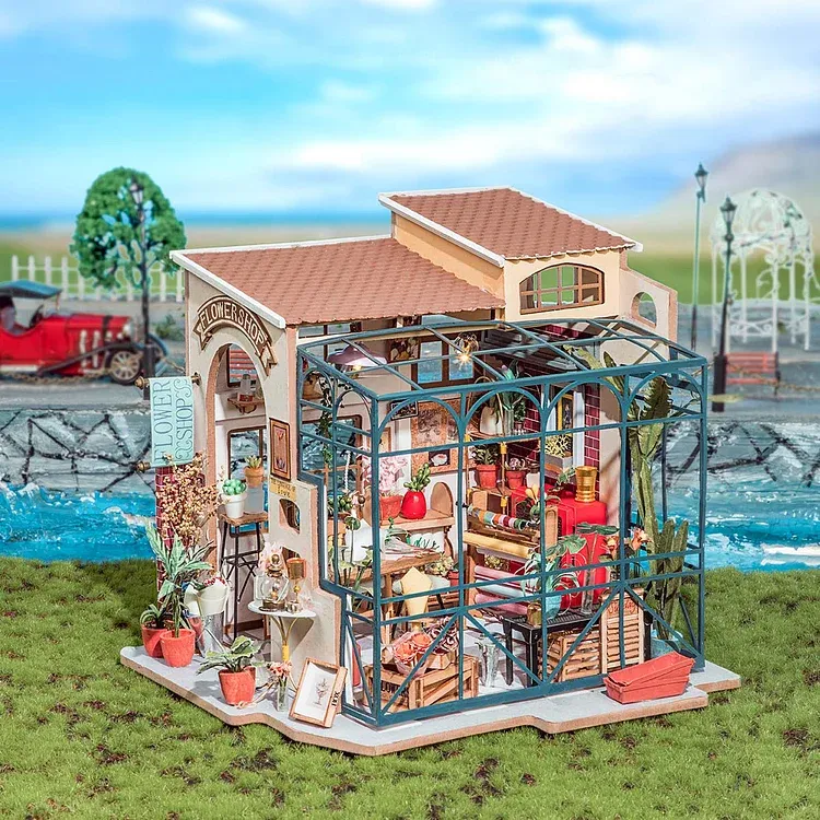 Rolife Emily's Flower Shop Miniature House. The western-designed exterior features decorative artwork and plants and a glassed-in patio.