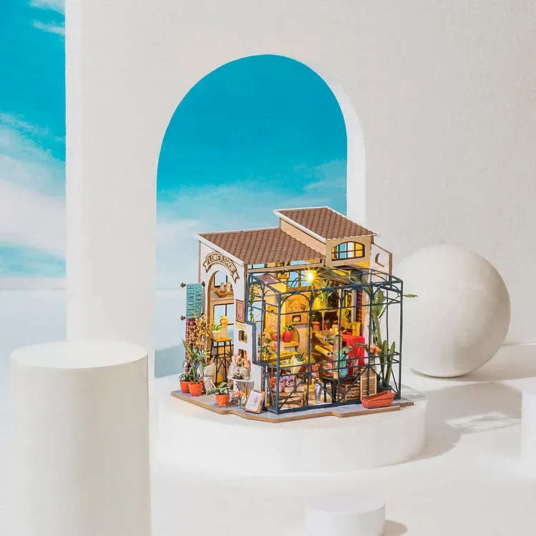 Rolife Emily's Flower Shop Miniature House. The western-designed exterior features decorative artwork and plants and a glassed-in patio.