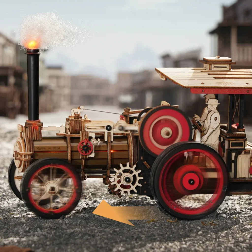 Fully assembled Rokr steam engine mechanical 3D wooden puzzle on a gravel street with a blurred old-time western town in the background.