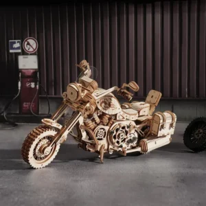 Detailed cruiser motorcycle 3D wooden puzzle displayed in warehouse with retro gas pump and tire.