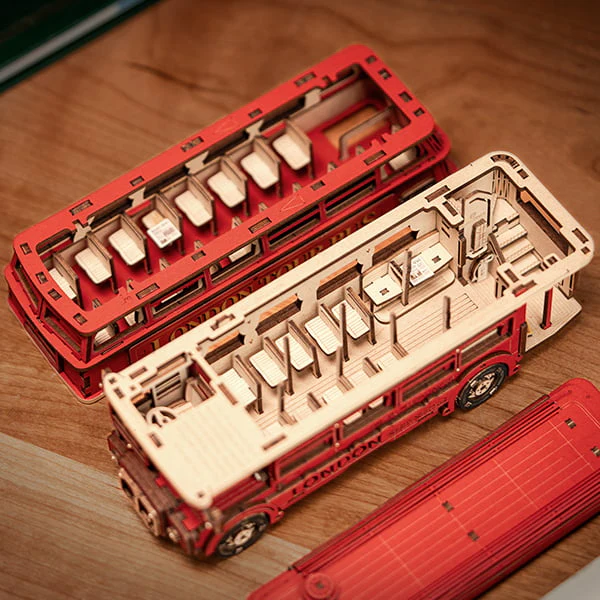 Rolife London Tour Bus 3D Wooden Puzzle kit with the top removed, showing the passenger seats and intricate craftsmanship.