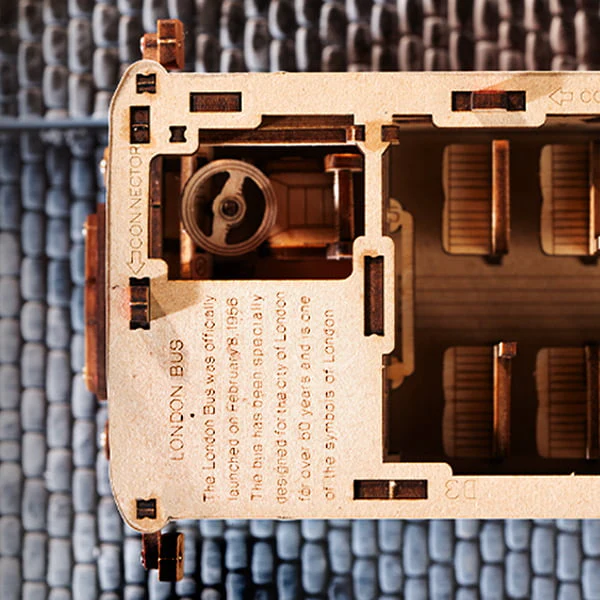 Close-up of the driver’s area in the Rolife London Tour Bus 3D Wooden Puzzle, with hidden inscriptions between decks showing the bus’s historical preservation.