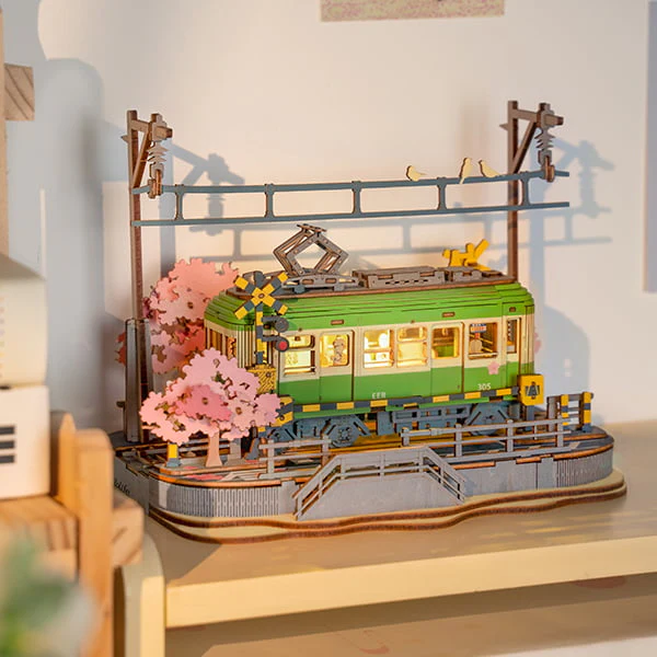 Fully assembled Sakura Journey 3D Wooden Puzzle on a wooden shelf.