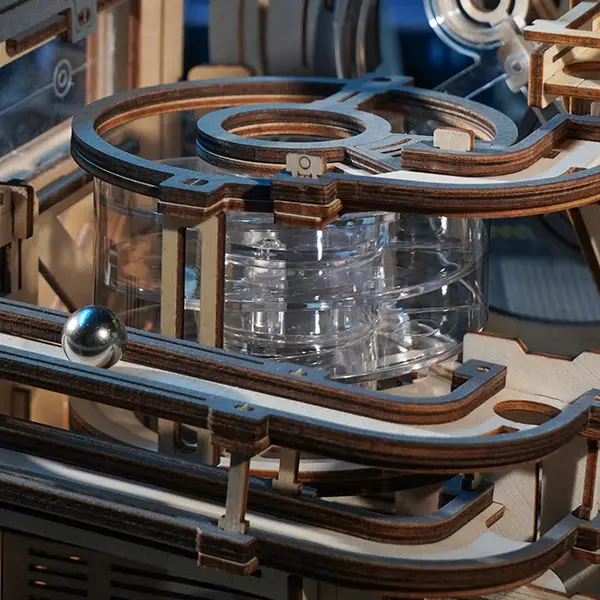 Marble traveling on a highly transparent plastic track in the ROKR Marble Spaceport 3D Puzzle.